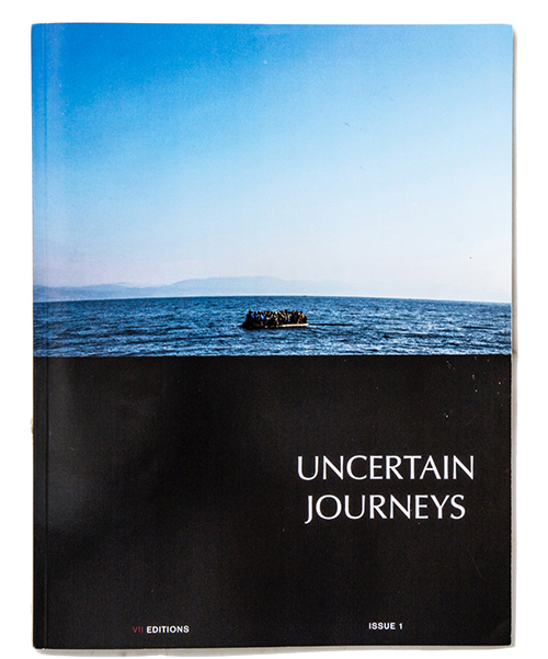 A cover of a magazine with a life raft floating in the ocean reading Uncertain Journeys