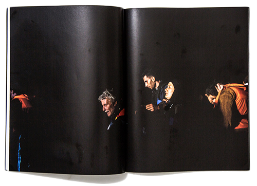 A magazine spread featuring migrants crossing a border in life jackets